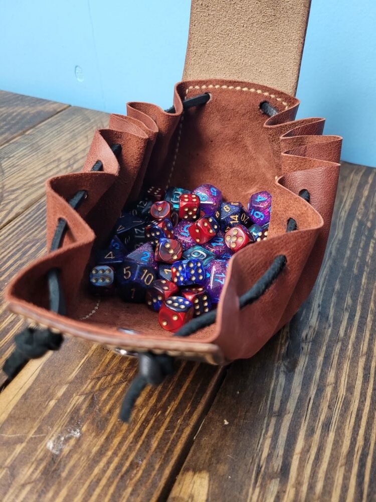 dice bag open and holding a mixture of dice colors and styles