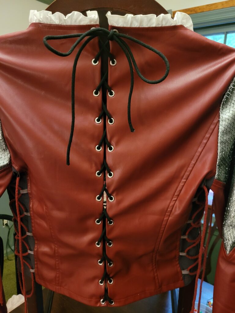 Too small shirt fix. Added eyelets to the back to make adjustable.